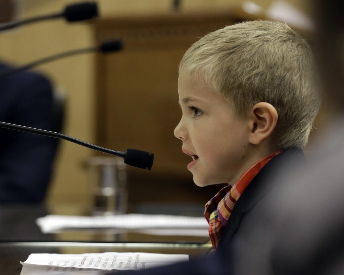 Rhett Krawitt, 7, who could not be vaccinated while he was being treated for leukemia, speaks to lawmakers in April in support of a bill requiring more children to be vaccinated.