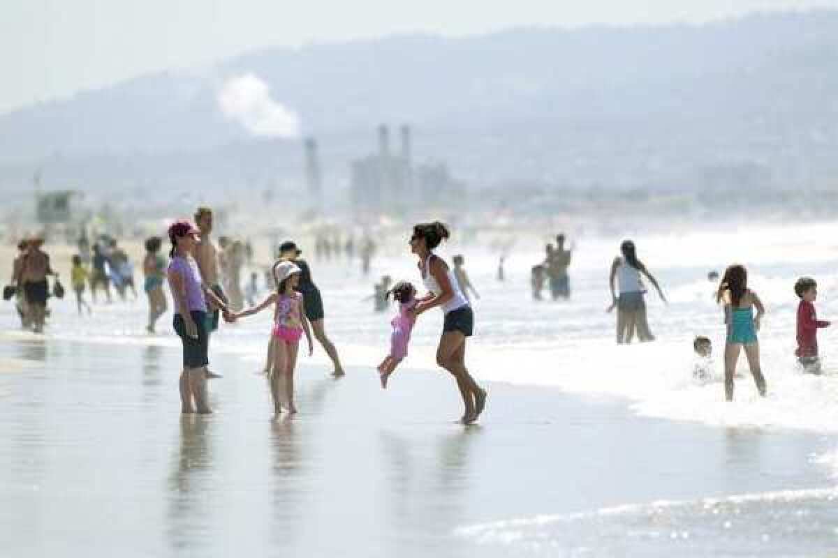 Families packed the shore of Manhattan Beach during 80-degree temperatures in 2011.