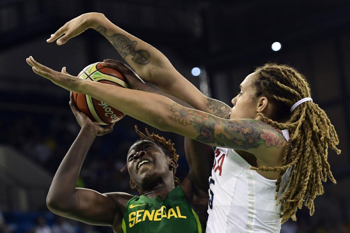 USA center Brittney Griner, right, defends against Senegal center Maimouna Diarra during a Group B women's basketball game on Aug. 7.