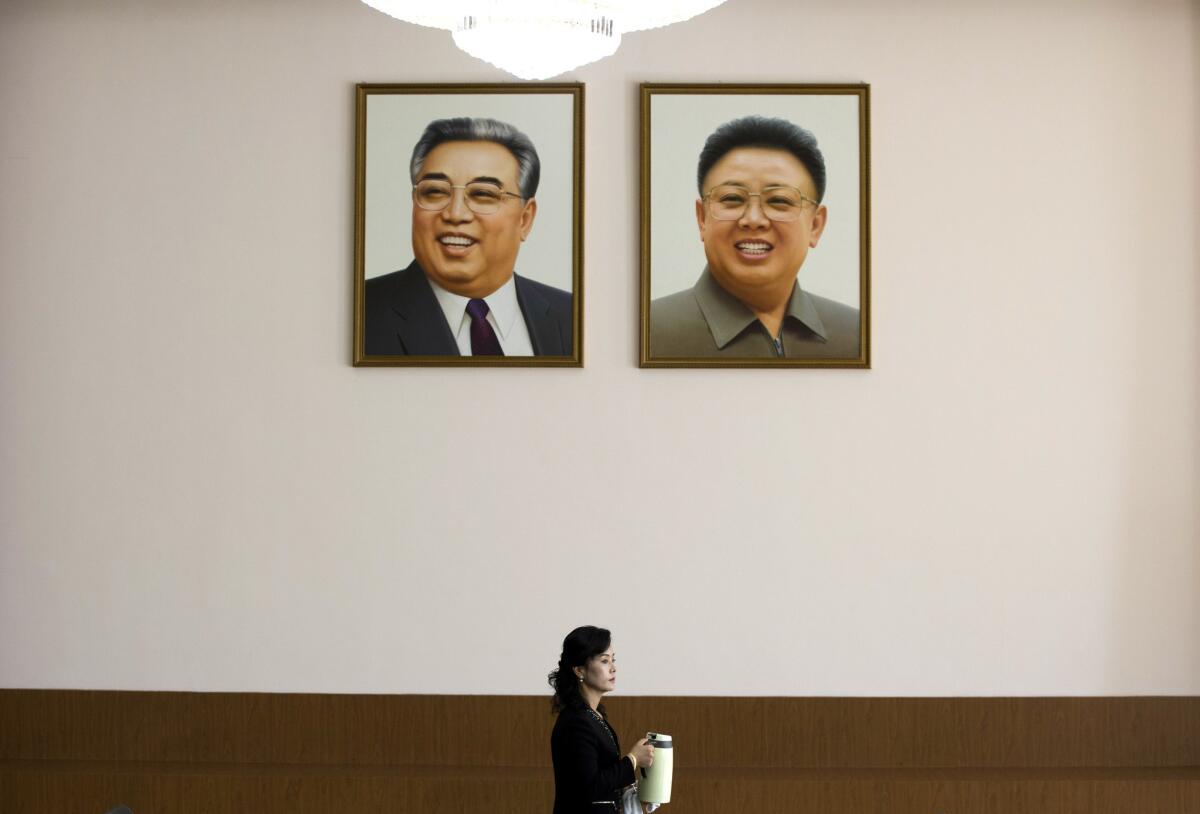 Kim Il Sung, left, and Kim Jong Il, seen in portraits hanging at the North Korean Embassy in Beijing, are the two authors whose works are most featured at the Foreign Language Bookshop in Pyongyang.