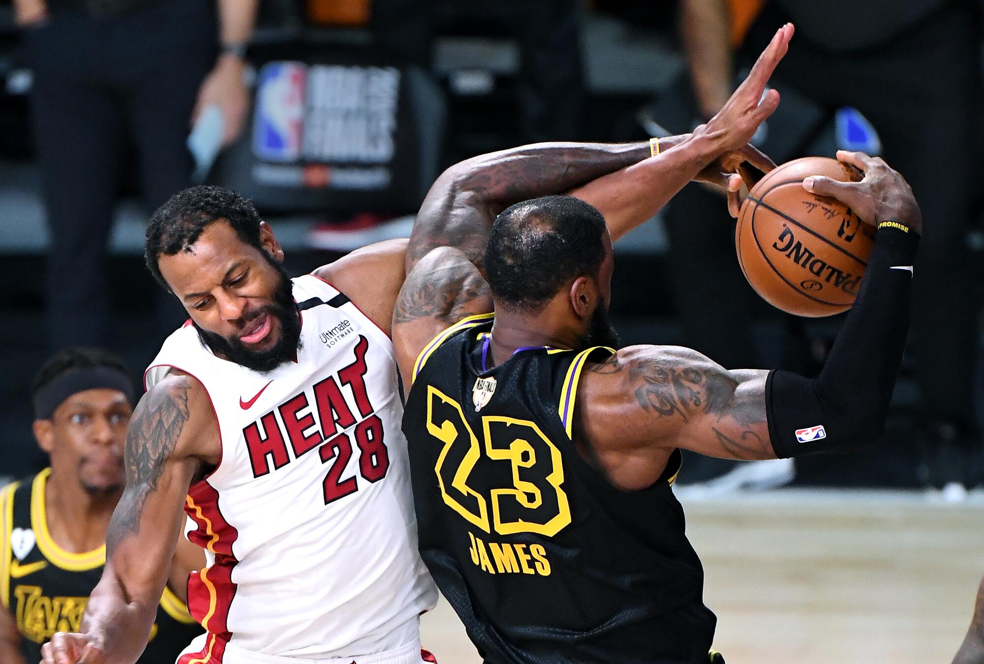 Lakers forward LeBron James grabs a rebound as he is fouled by Miami Heat guard Andre Iguodala.