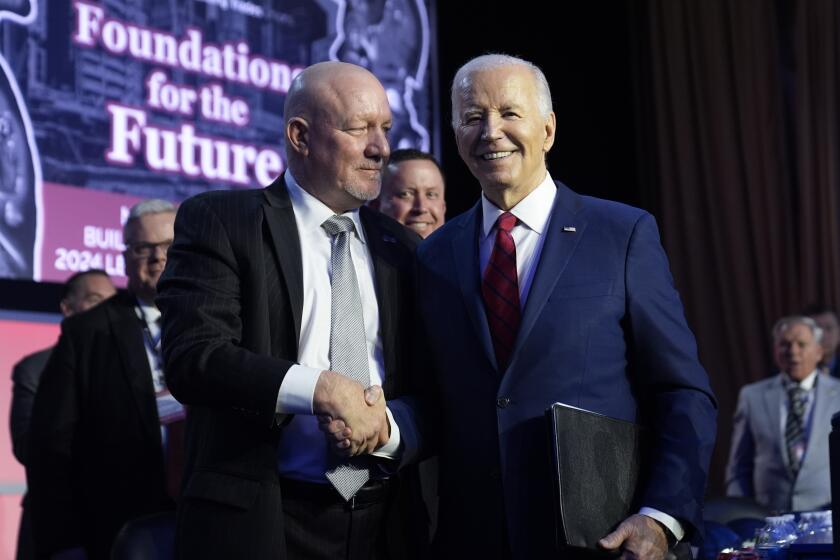 President Joe Biden talks with NABTU President Sean McGarvey after speaking to the North America's Building Trade Union National Legislative Conference, Wednesday, April 24, 2024, in Washington. (AP Photo/Evan Vucci)