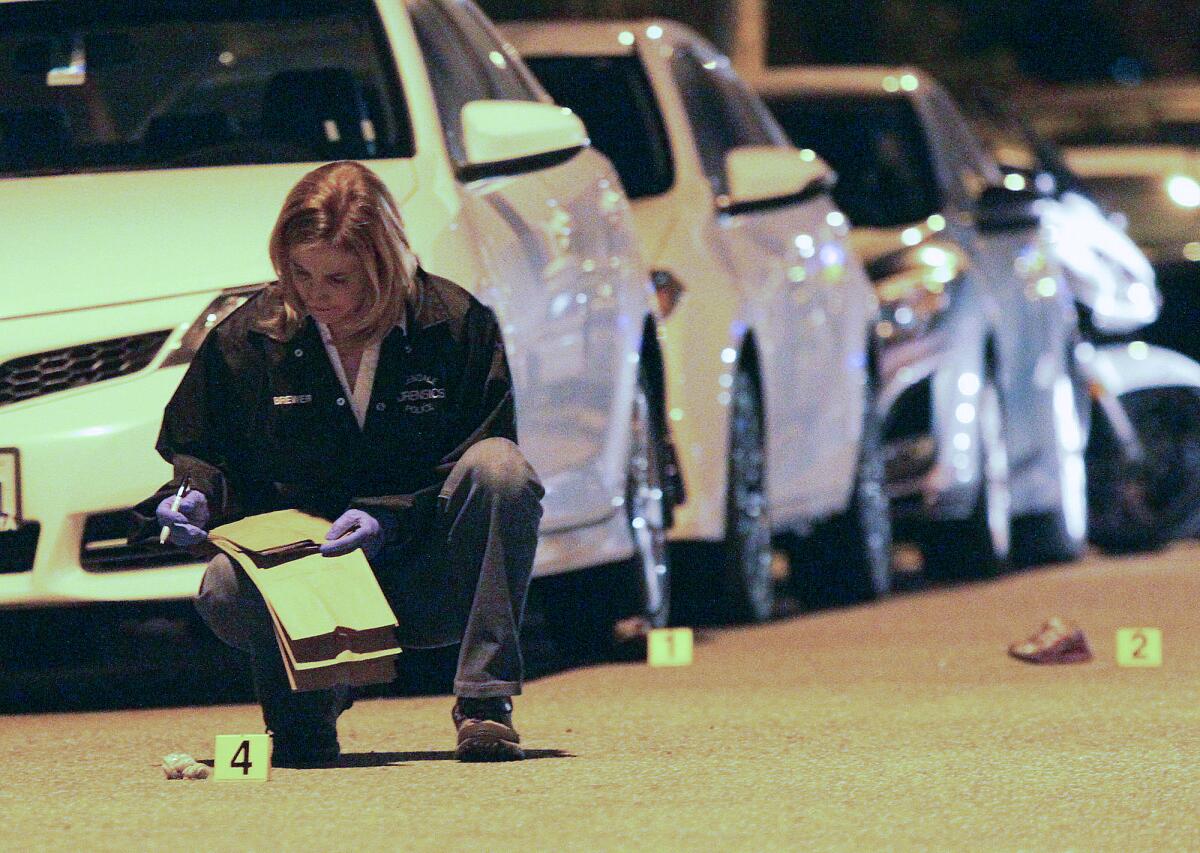 A Glendale Police Department Forensics officer documents evidence at the scene of a hit-and-run where a 4-year-girl was killed at the intersection of Olive Street and Wilson Avenue in Glendale on Friday, March 6, 2015.
