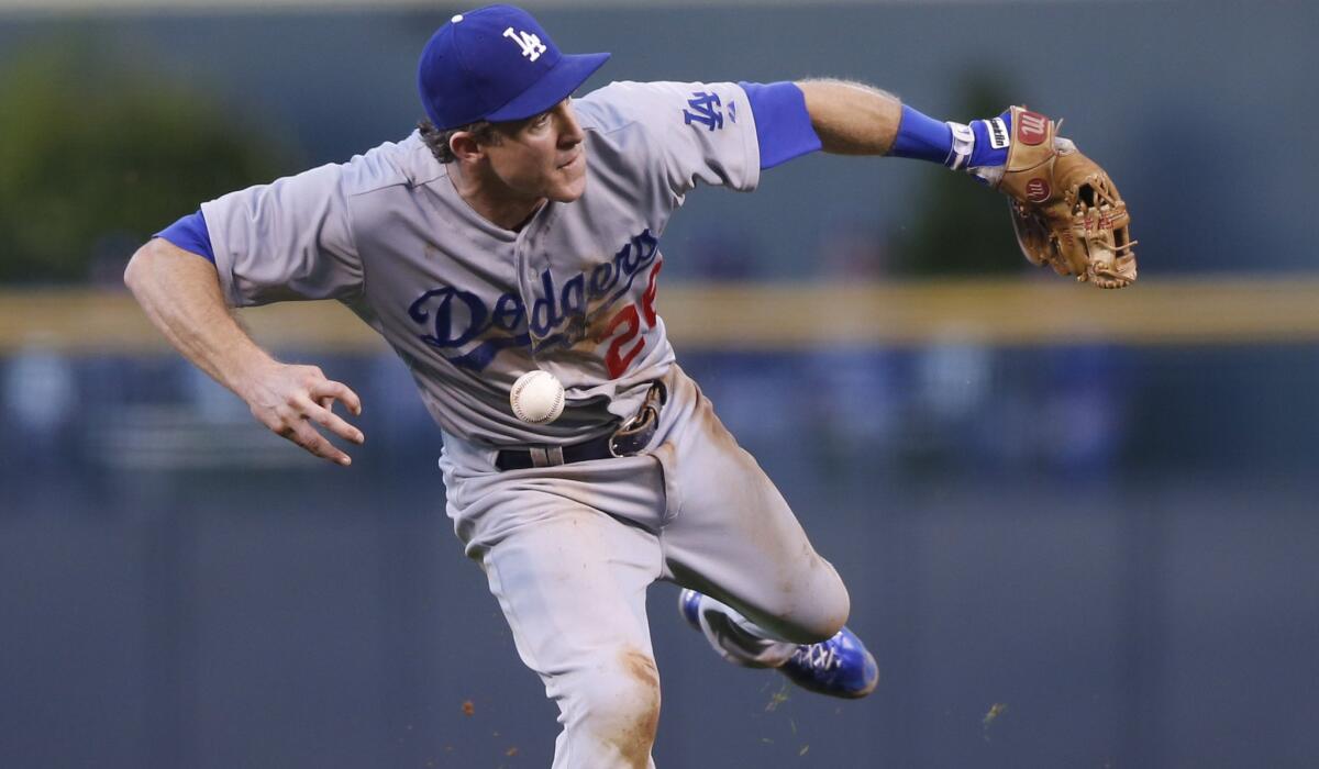 Dodgers second baseman Chase Utley bobbles a ground ball off the bat of Colorado's Justin Morneau during Saturday's game in Denver.