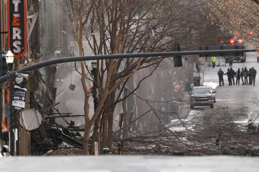 Emergency personnel work at the scene of an explosion in downtown Nashville, Tenn., Friday, Dec. 25, 2020. Buildings shook in the immediate area and beyond after a loud boom was heard early Christmas morning.(AP Photo/Mark Humphrey)