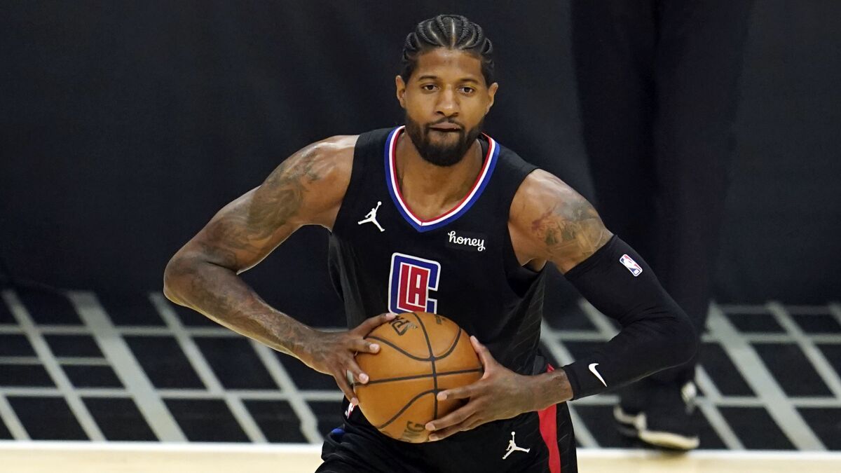 Los Angeles Clippers guard Paul George passes the ball