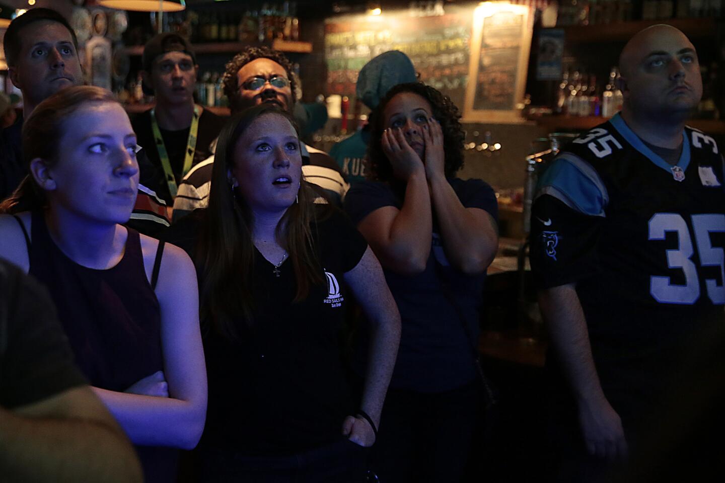 Carolina Panthers fans watch Super Bowl 50 during a pensive moment at Beelman's Pub in downtown Los Angeles. Most of the fans at Beelman's are part of the Roaring Riot, the largest unofficial Panthers fan union in the nation.