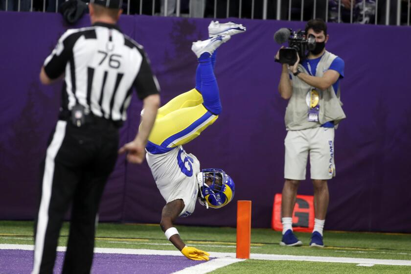 Los Angeles Rams' Brandon Powell flips into the end zone during a 61-yard punt return for a touchdown in the second half of an NFL football game against the Minnesota Vikings, Sunday, Dec. 26, 2021, in Minneapolis. (AP Photo/Bruce Kluckhohn)