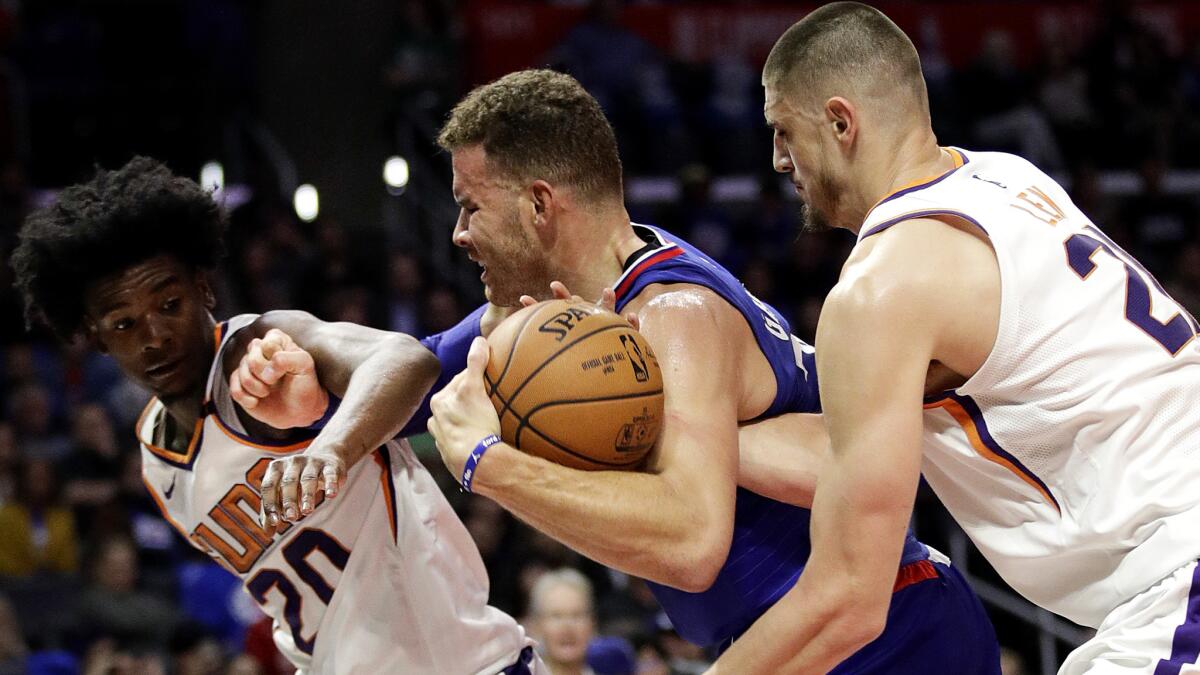 Clippers forward Blake Griffin tries to power his way past Phoenix's Josh Jackson, left, and Alex Len during the second half Saturday.