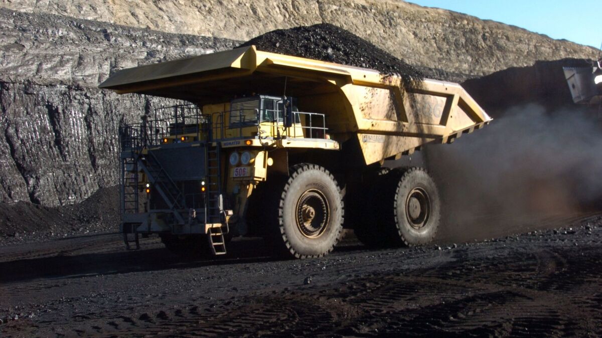 A truck capable of carrying 250 tons of coal carries a load from a strip mine near Decker, Mont. 