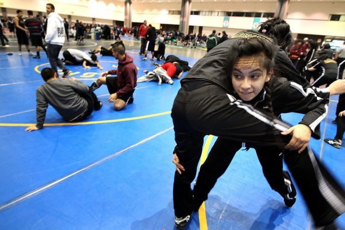 Panorama High wrestlers Leslie de los Reyes, right, and Josselyn Pacheco practice before a tournament.