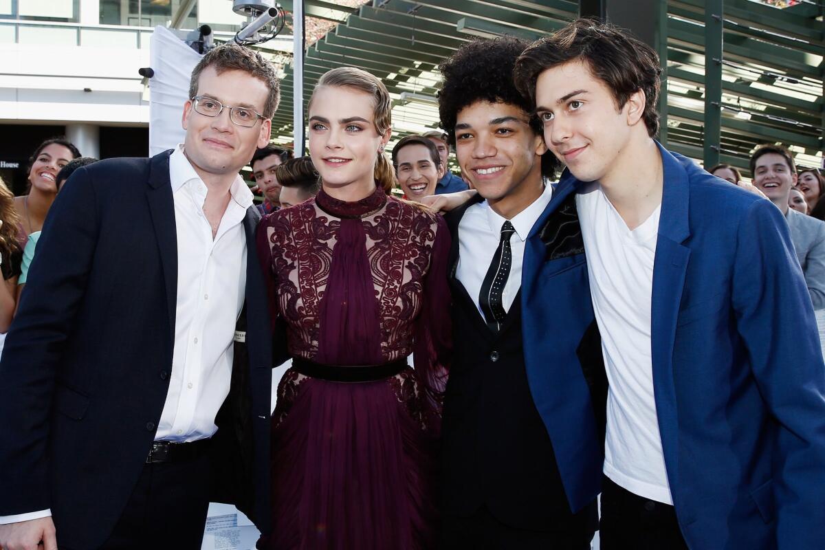 John Green, left, with "Paper Towns" cast members Cara Delevingne, Justice Smith and Nat Wolff, attends the 2015 MTV Movie Awards. Green has a cameo in the film.