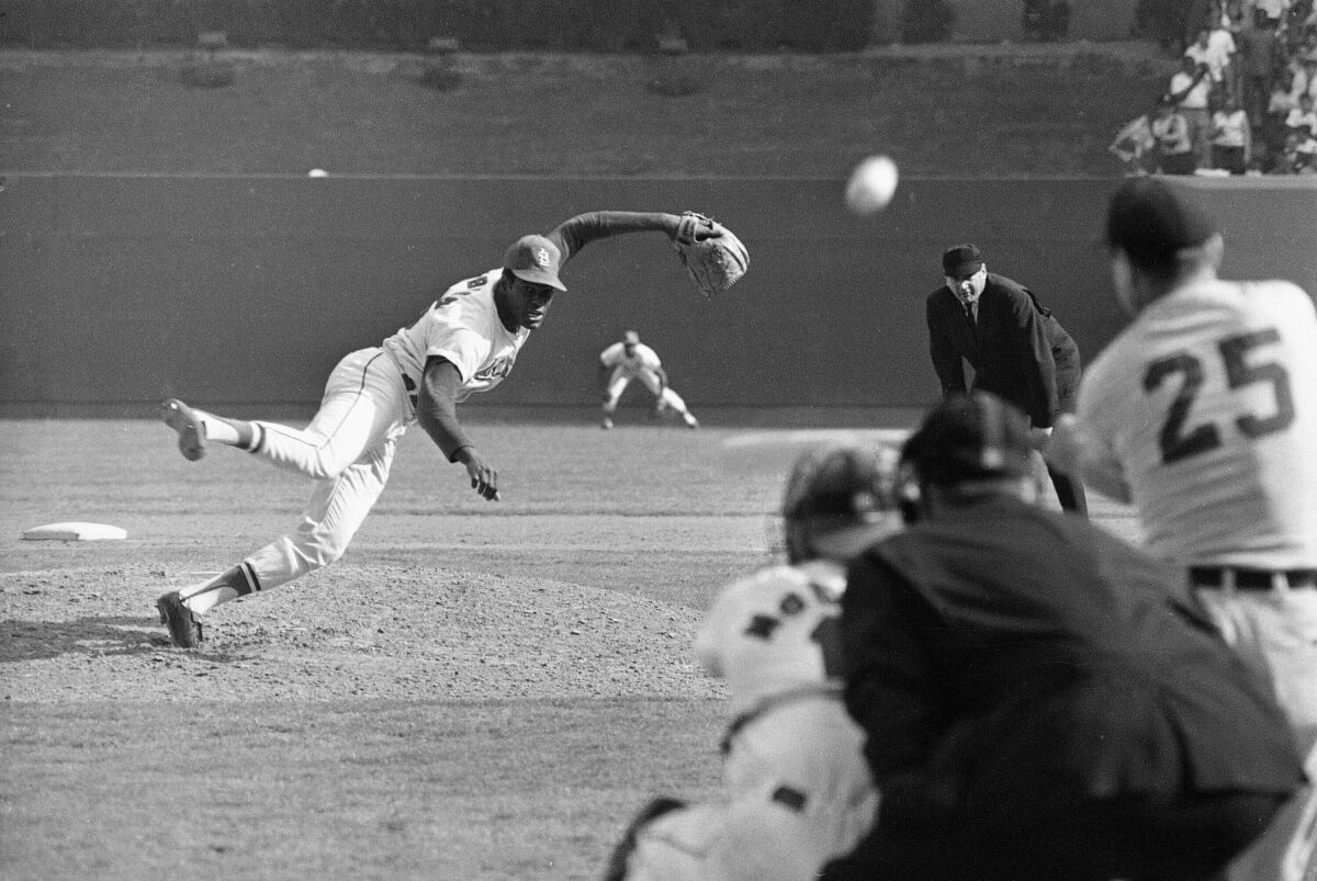 FILE - In this Oct. 2, 1968, file photo, St. Louis Cardinals ace pitcher Bob Gibson throws to Detroit Tigers' Norm Cash during the ninth inning of Game 1 of the baseball World Series at Busch Stadium in St. Louis. Gibson, the dominating pitcher who won a record seven consecutive World Series starts and set a modern standard for excellence when he finished the 1968 season with a 1.12 ERA, died Friday, Oct. 2, 2020. He was 84. (AP Photo, File)