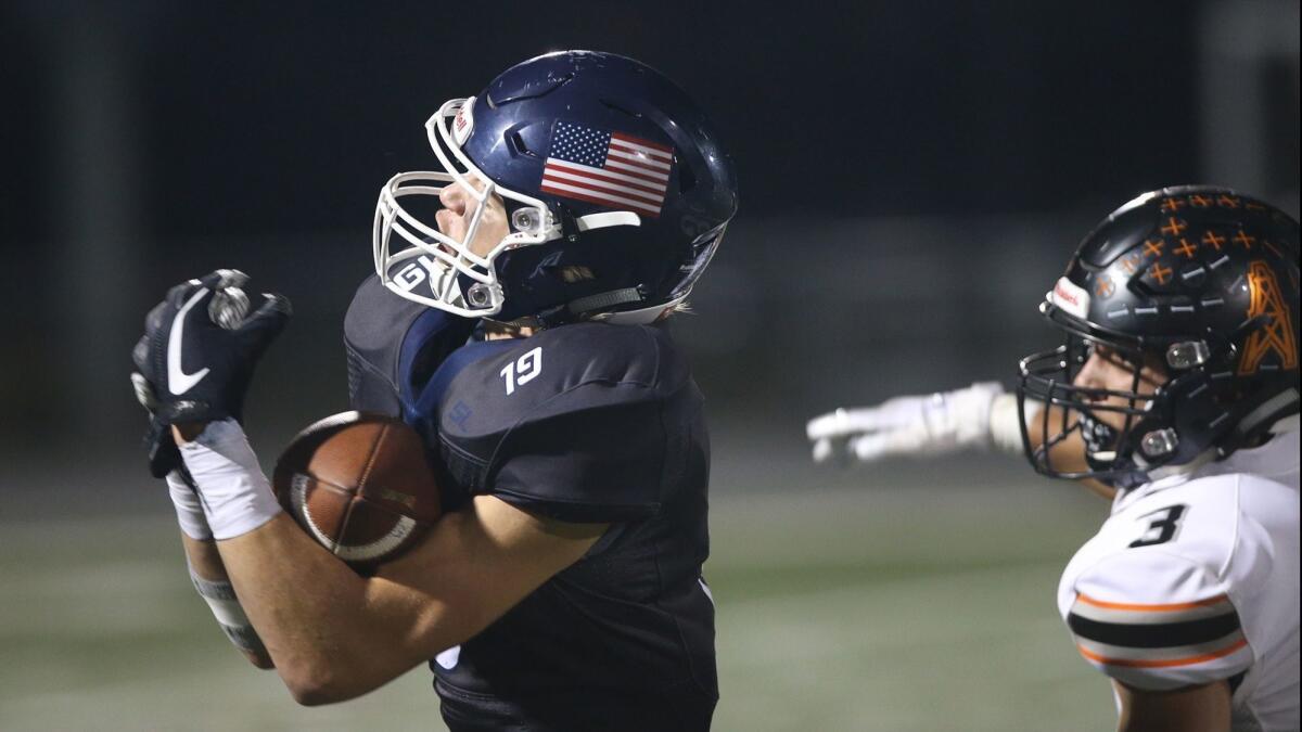 Newport Harbor High wide receiver Aiden Goltz, pictured making a catch against Huntington Beach on Sept. 28, will try to help the Sailors upset Los Alamitos on Friday.