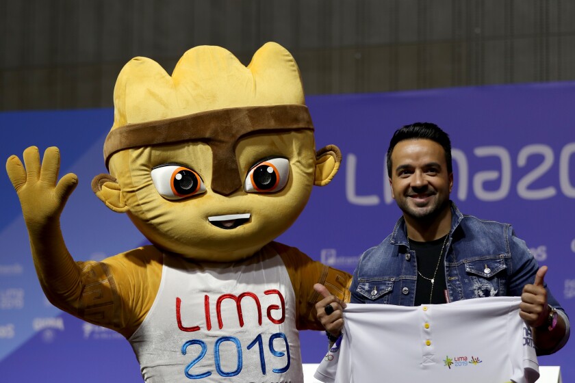LIMA, PERU - JULY 22: Puerto Rican singer Luis Fonsi and official tournament mascot Milco pose for pictures during a press conference at Lima Convention Centre on July 22, 2019 in Lima, Peru. Fonsi will perform in the Opening Ceremony of Lima 2019 Pan American Games to be held at Estadio Nacional on July 26th. (Photo by Buda Mendes/Getty Images) ** OUTS - ELSENT, FPG, CM - OUTS * NM, PH, VA if sourced by CT, LA or MoD **
