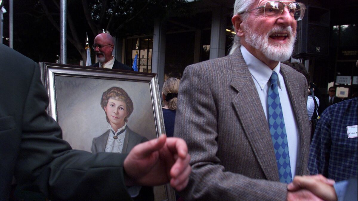 Truman Toland, great-grandson of Clara Shortridge Foltz and painter of the portrait of her at left, greets guests at the rededication of the LA Criminal Courts Building in her honor in Los Angeles on Feb. 8, 2002.