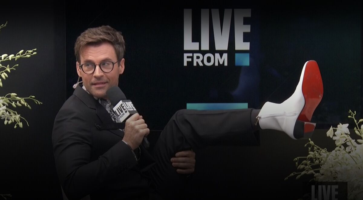 Host Brad Goreski, in Dior, shows off his white boots with red soles on E!