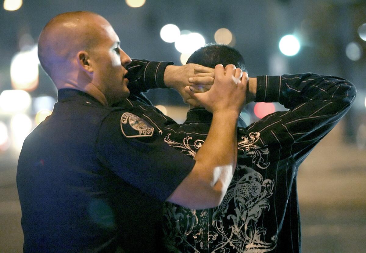 File Photo: Glendale police officer Kyle Heinbechner searches a car occupant at a DUI checkpoint on Los Feliz Blvd. at San Fernando Rd. on Friday, January 2, 2009. Seven motorists were arrested Saturday, August 31, 2013 during saturation patrols focused on drunk driving in Glendale.