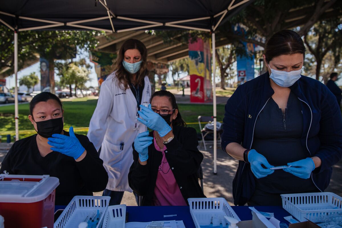 A nursing student from Southwestern College and Champions for Health workers prepared vaccines in Chicano Park on March 27.