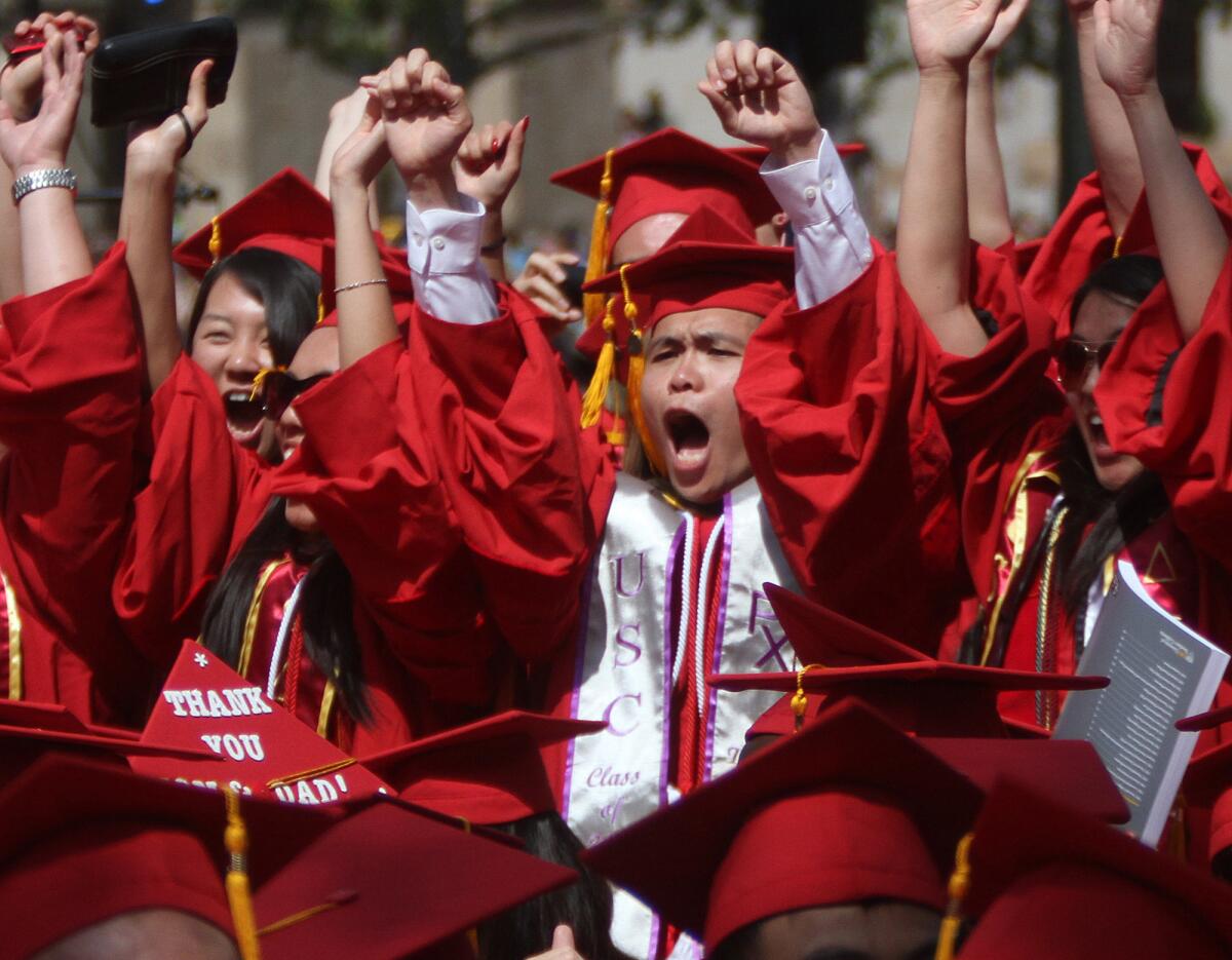 USC students cheer during their graduation ceremony last year. A new poll suggests that satisfaction with later life does not depend much on which college students attended.