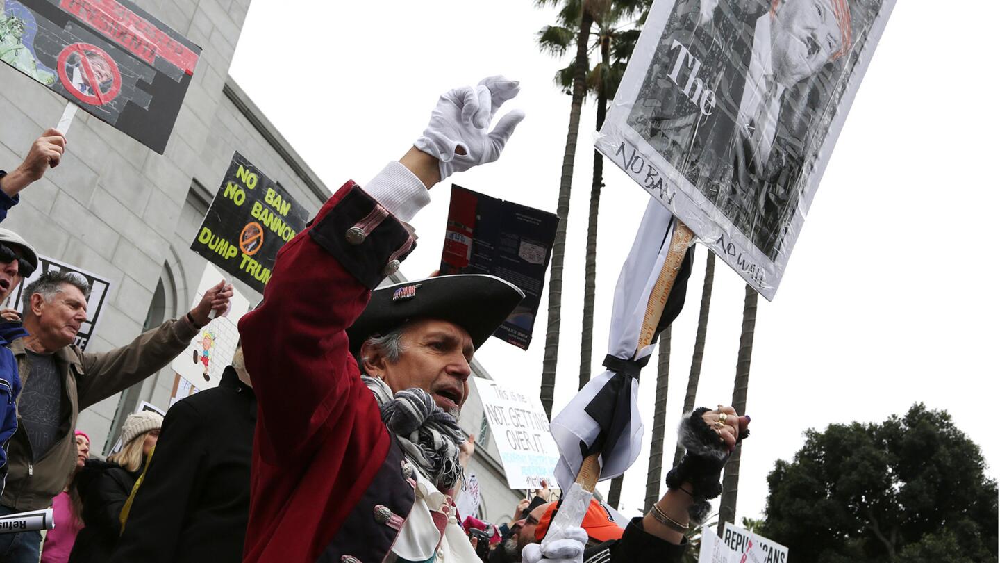 Lawrence Herrera of Los Angeles appears in a colonial costume for the protests outside Los Angeles City Hall.