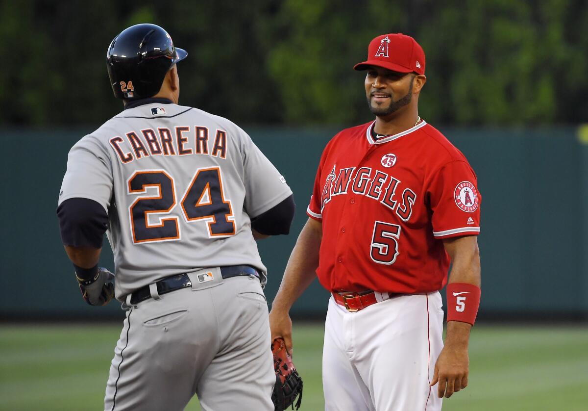 Detroit Tigers designated hitter Miguel Cabrera, left, jogs past Angels first baseman Albert Pujols after hitting a solo home run Monday.