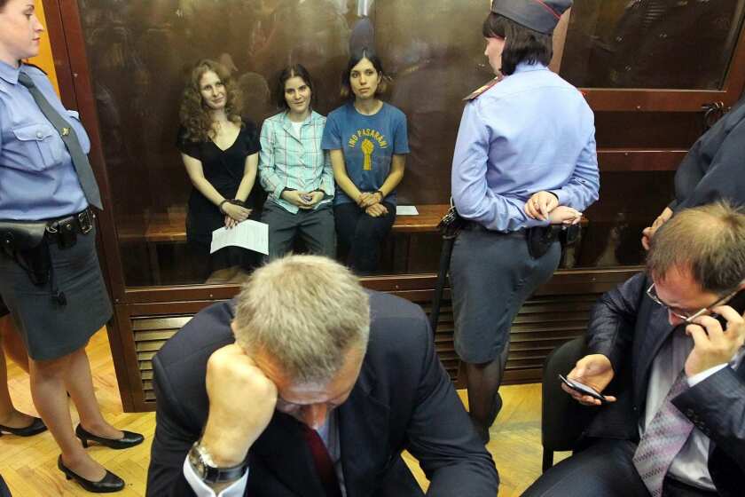 Russian feminist punk-rock band Pussy Riot members Maria Alyokhina, left, Yekaterina Samutsevich and Nadezhda Tolokonnikova sit in a glass-walled cage in a courtroom after the judge delivered the verdict at the Khamovnichesky Court in Moscow. Judge Marina Syrova sentenced the trio, who were found guilty of hooliganism motivated by religious hatred or hostility after singing a song insulting Vladimir Putin in the Christ the Savior Cathedral in Moscow earlier this year ahead of presidential elections in Russia, to two years in prison.