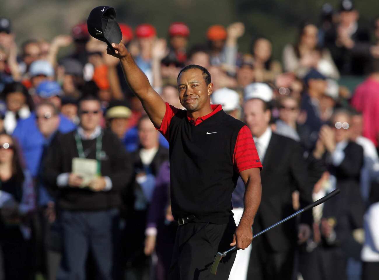 An emotional Tiger Woods acknowledges the cheers of the gallery after winning the Chevron World Challenge on Sunday at Sherwood Country Club in Thousand Oaks.