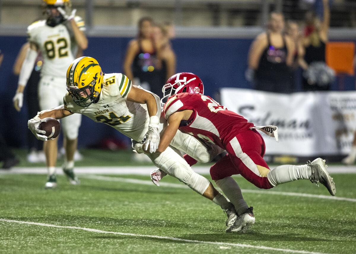 Edison's Troy Fletcher stretches out for a touchdown against Orange Lutheran's Noah Rodriguez during Friday's game.