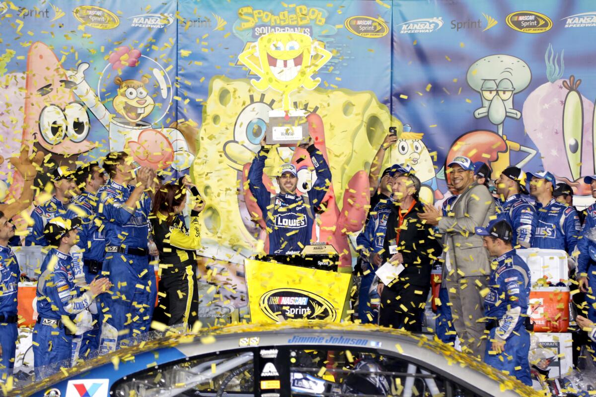 Jimmie Johnson celebrates after winning the NASCAR Sprint Cup Series race at Kansas Speedway on Saturday.