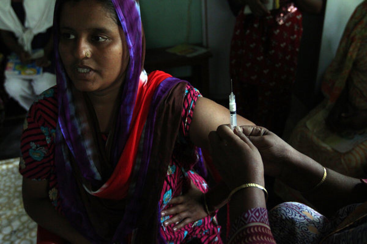 A mother of two in Matlab, Bangladesh, prepares to receive a hormone shot that will protect her from pregnancy for three months. Bangladesh has made access to contraceptives a priority, unlike many fast-growing nations in Africa.