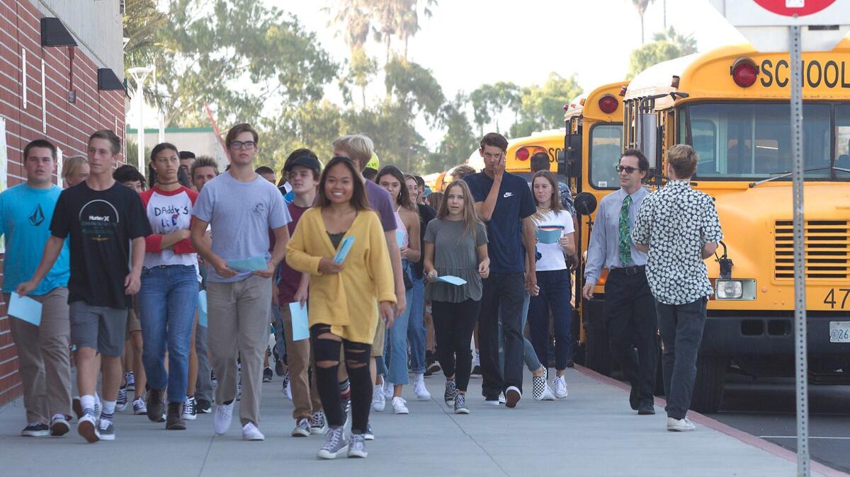 Students arrive on the first day of school Wednesday at Edison High School in Huntington Beach.