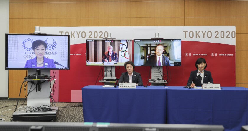 This photo shows the opening remark session of a five-party meeting held by the Tokyo Organizing Committee of the Olympic and Paralympic Games (Tokyo 2020) at the Tokyo 2020 headquarters in Tokyo on Wednesday, March 3, 2021. From left are, Tokyo Gov. Yuriko Koike, Thomas Bach, back center, president of the International Olympic Committee (IOC), Andrew Parsons, president of the International Paralympic Committee, Seiko Hashimoto, front row, left, president of the Tokyo 2020 Organizing Committee, and Tamayo Marukawa, minister for the Tokyo Olympic and Paralympic Games. (Du Xiaoyi/Pool Photo via AP)