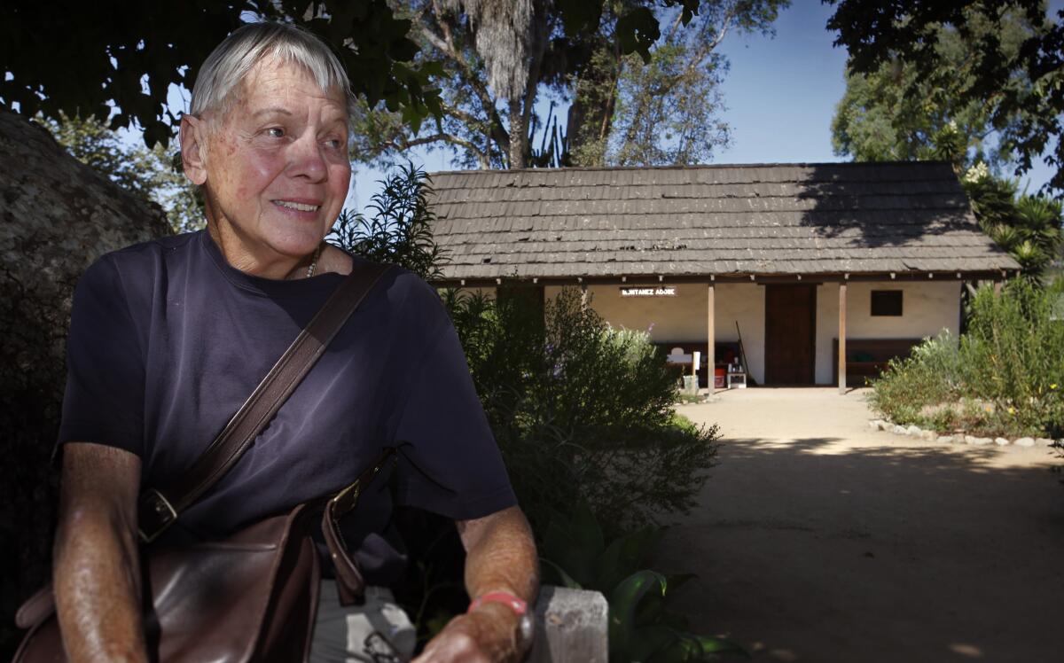Ilse Byrnes sits in front of the restored 1794 Montanez Adobe house in San Juan Capistrano in 2013. 