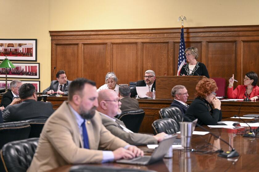 Lawmakers in the West Virginia House of Delegates House and Human Resources Committee discuss a bill that would prohibit certain type of health care for transgender minors in a committee room at the West Virginia State Capitol in Charleston, W.Va. on Friday, Feb. 23, 2024. (Perry Bennett/West Virginia Legislative Photography via AP)