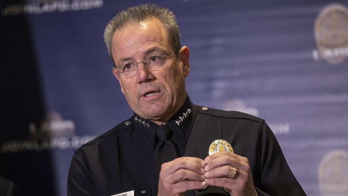 LAPD Chief Michel Moore says the department is downsizing its specialized units to preserve patrols and community engagement.