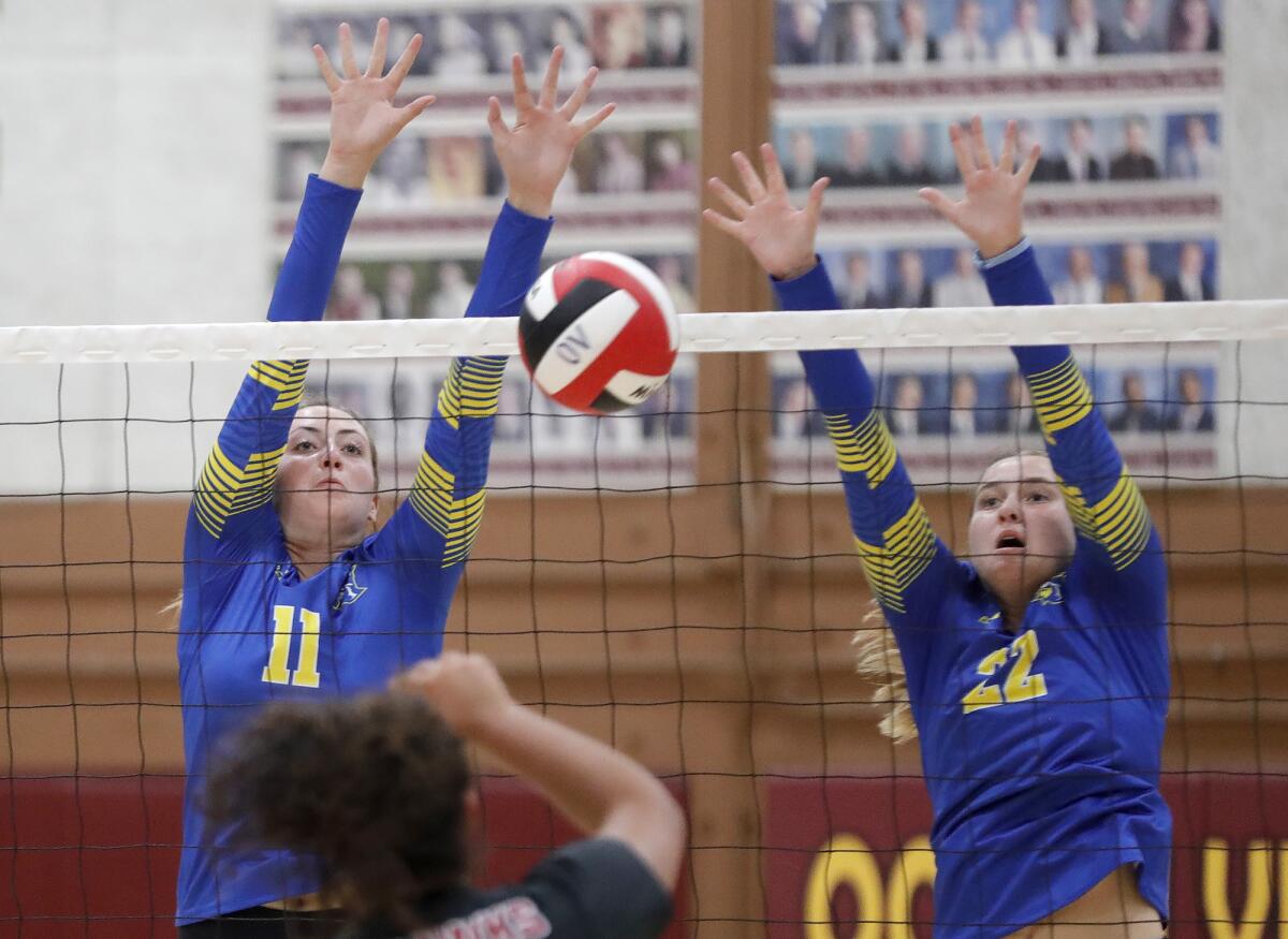 Fountain Valley's London Braithwaite (11) and Rebecca Staffieri (11) go up for a block against Ocean View on Monday.