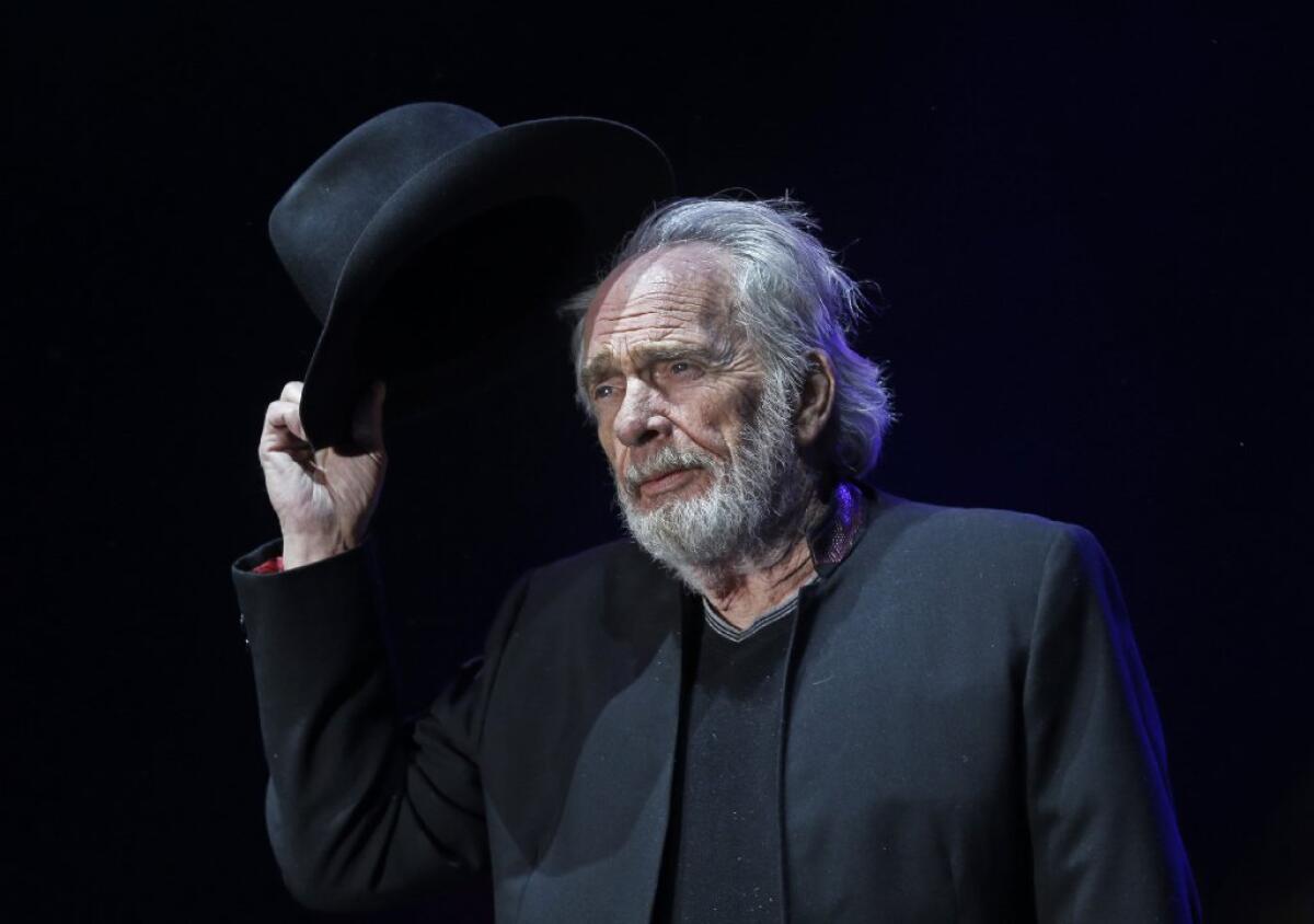 Merle Haggard tips his hat to the crowd as he begins to perform on the Palomino Stage on the first night of the sold-out three-day Stagecoach Country Music Festival at the Empire Polo Club in Indio on Friday.