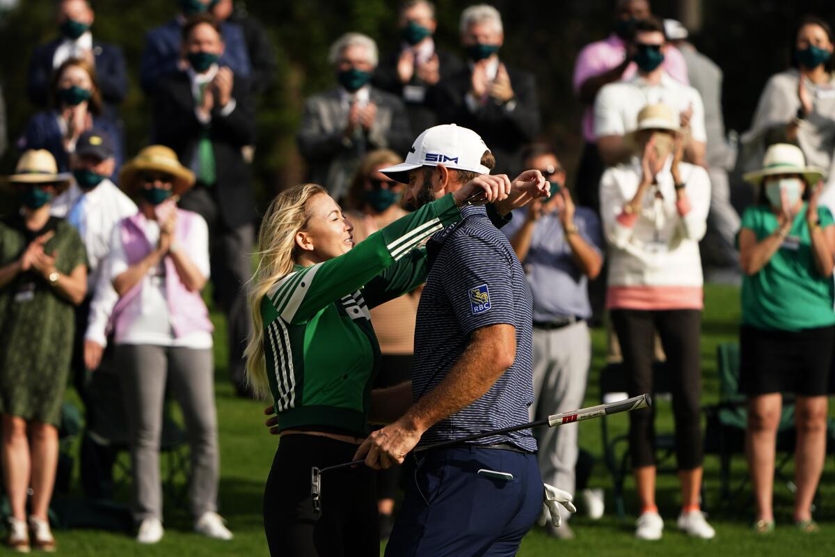 Dustin Johnson is hugged by Paulina Gretzky after his Masters win.