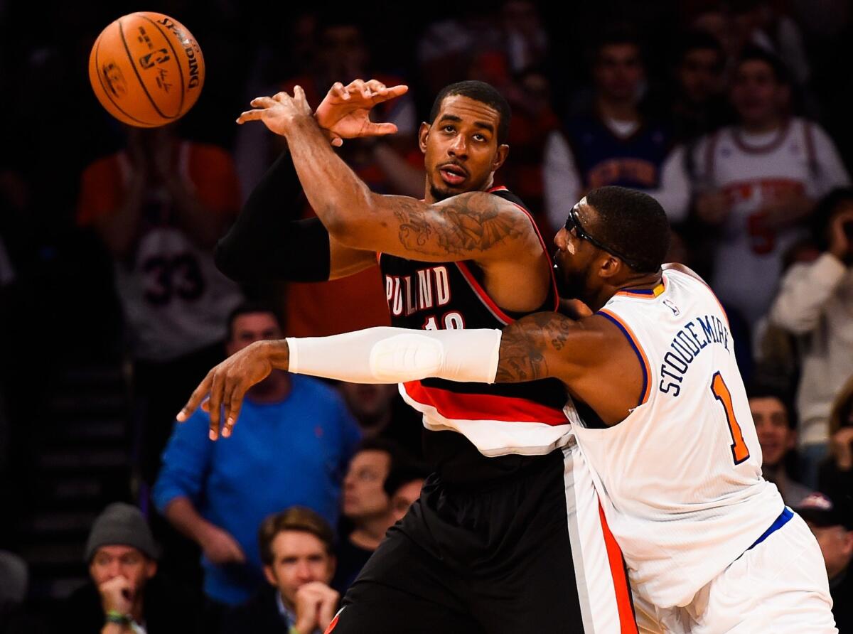 Knicks power forward Amare Stoudemire knocks the ball from the grasp of Trail Blazers power forward LaMarcus Aldridge as he posts up during their game Sunday at Madison Square Garden.