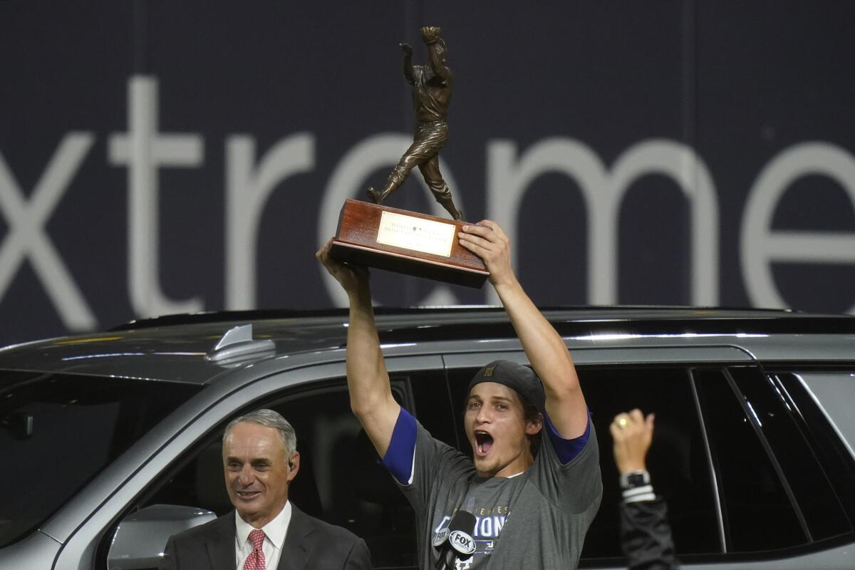 Dodgers shortstop Corey Seager holds up the World Series MVP trophy.