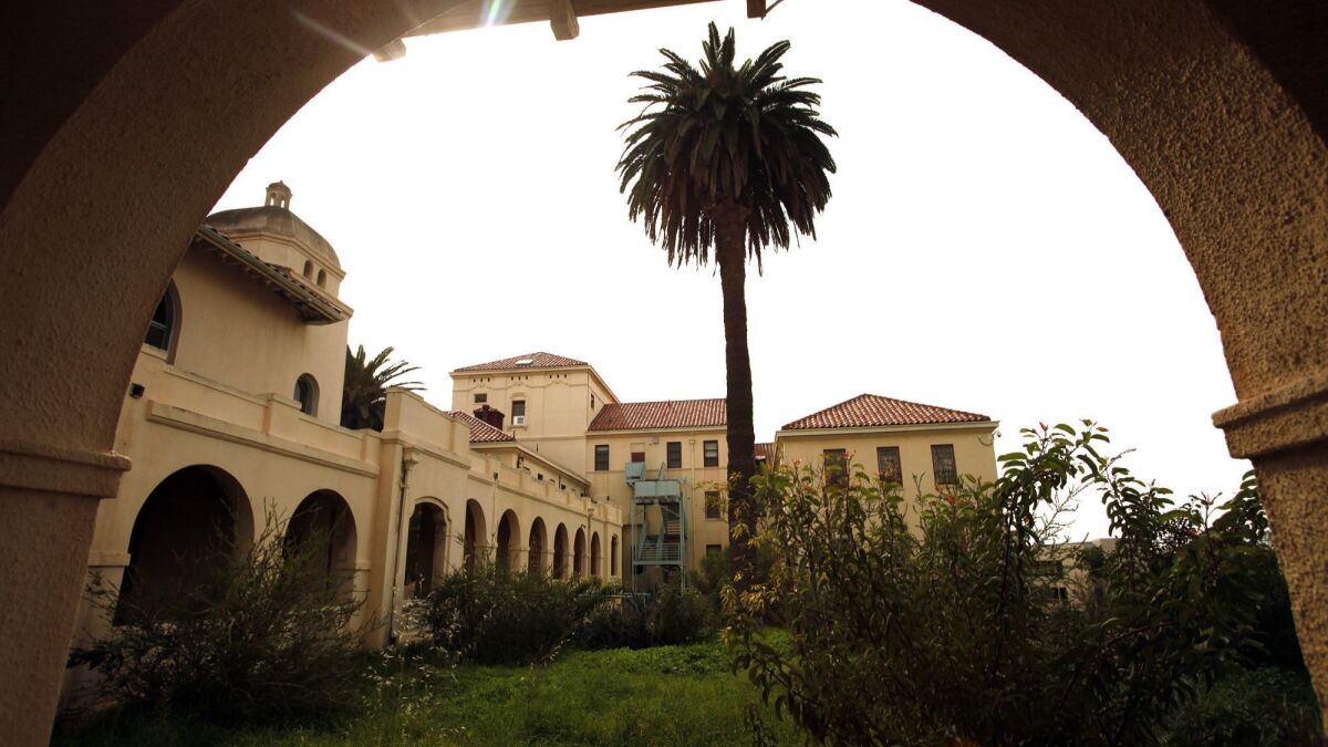 An archway frames buildings on the West L.A. Veterans Affairs campus, parts of which were leased to a parking lot operator in a bribery scheme that ended with the sentencing of former contract officer Ralph J. Tillman.