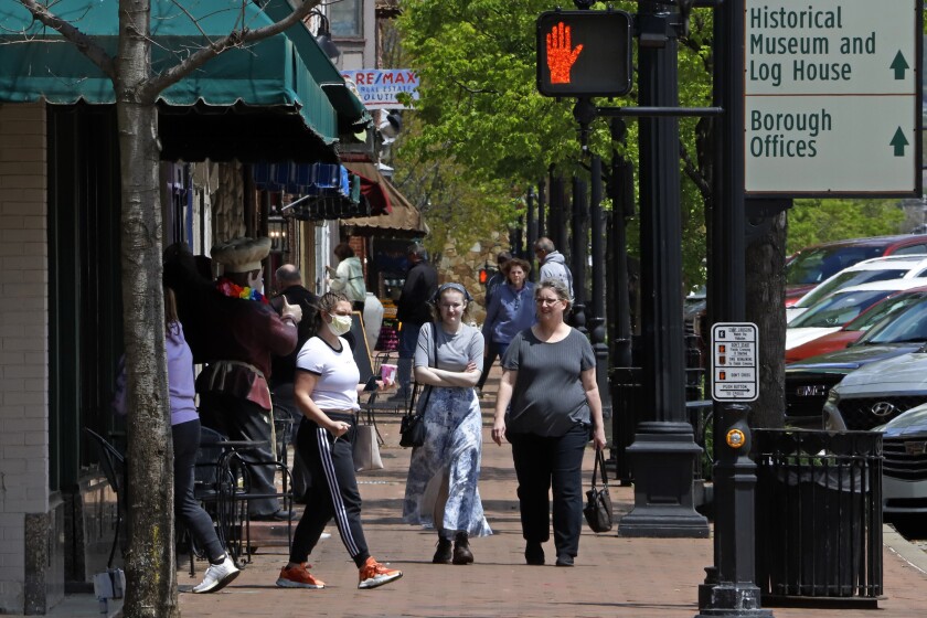 People gather outside shops in Beaver, Pa., as  Gov. Tom Wolf struggles to fight a Republican revolt over his stay-at-home orders and business shutdowns.