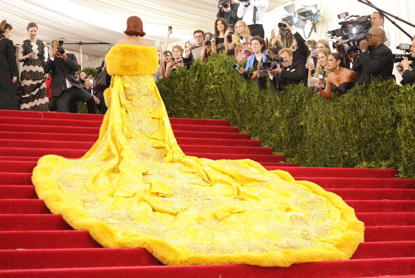 Rihanna's yellow fur-trimmed, embroidered cape makes a lasting impression on the red carpet at the Met Gala in New York on Monday evening.