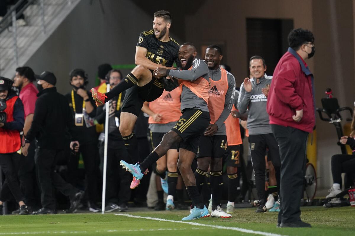 LAFC midfielder Ryan Hollingshead celebrates with defender Sebastien Ibeagha.