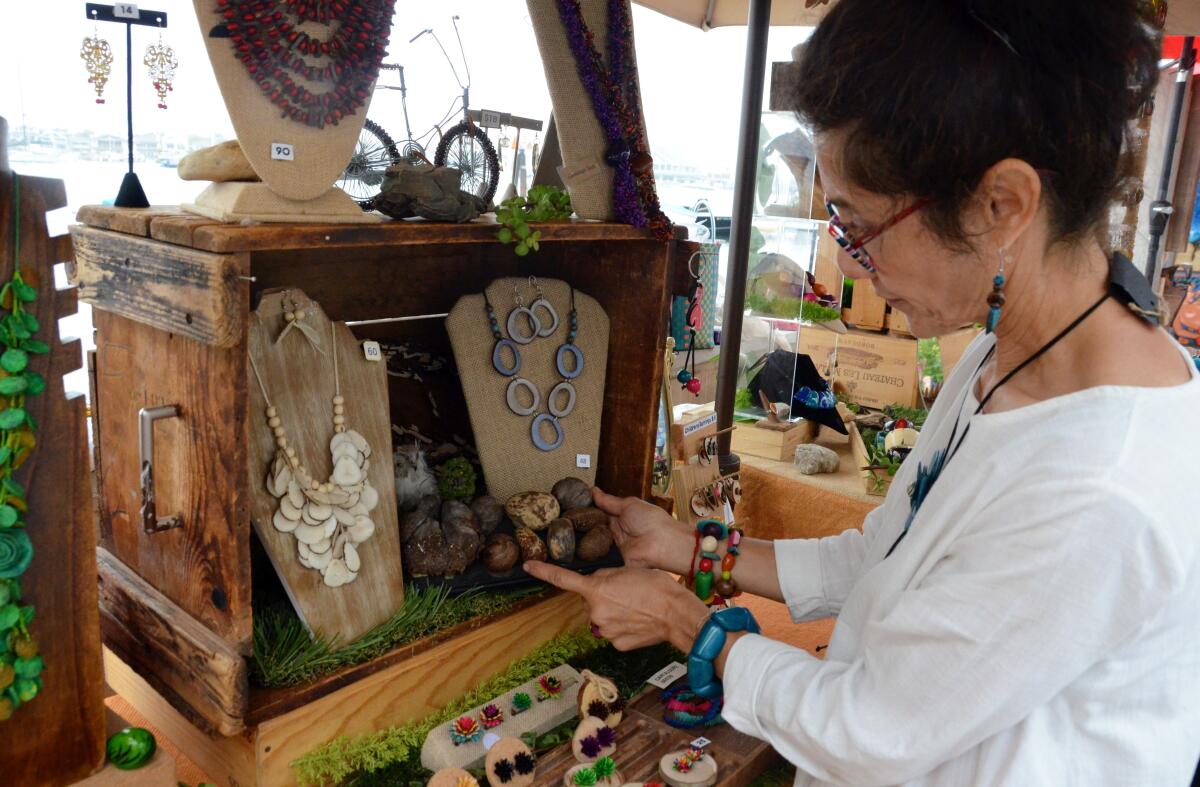 Artist Sandra Lopez shows tagua nut in original form prior to becoming an organic necklace.