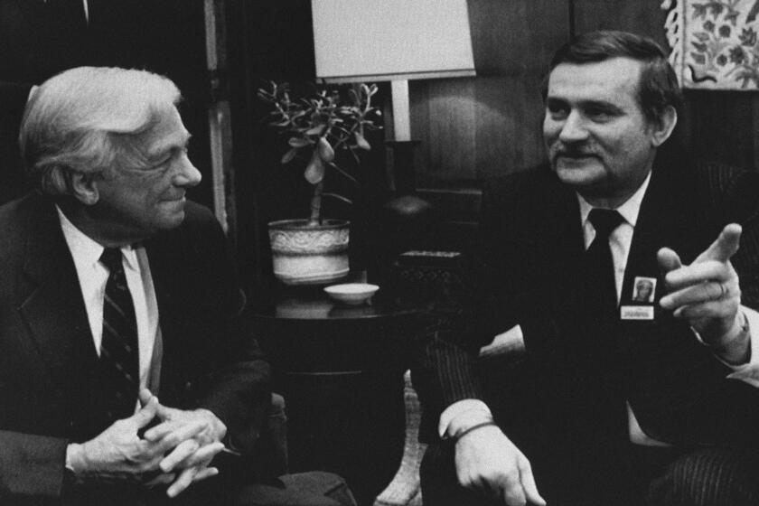 The late John C. Whitehead, left, meeting with Solidarity leader Lech Walesa in 1988: You won't be reading much about how he cost the Getty Trust $400 million.