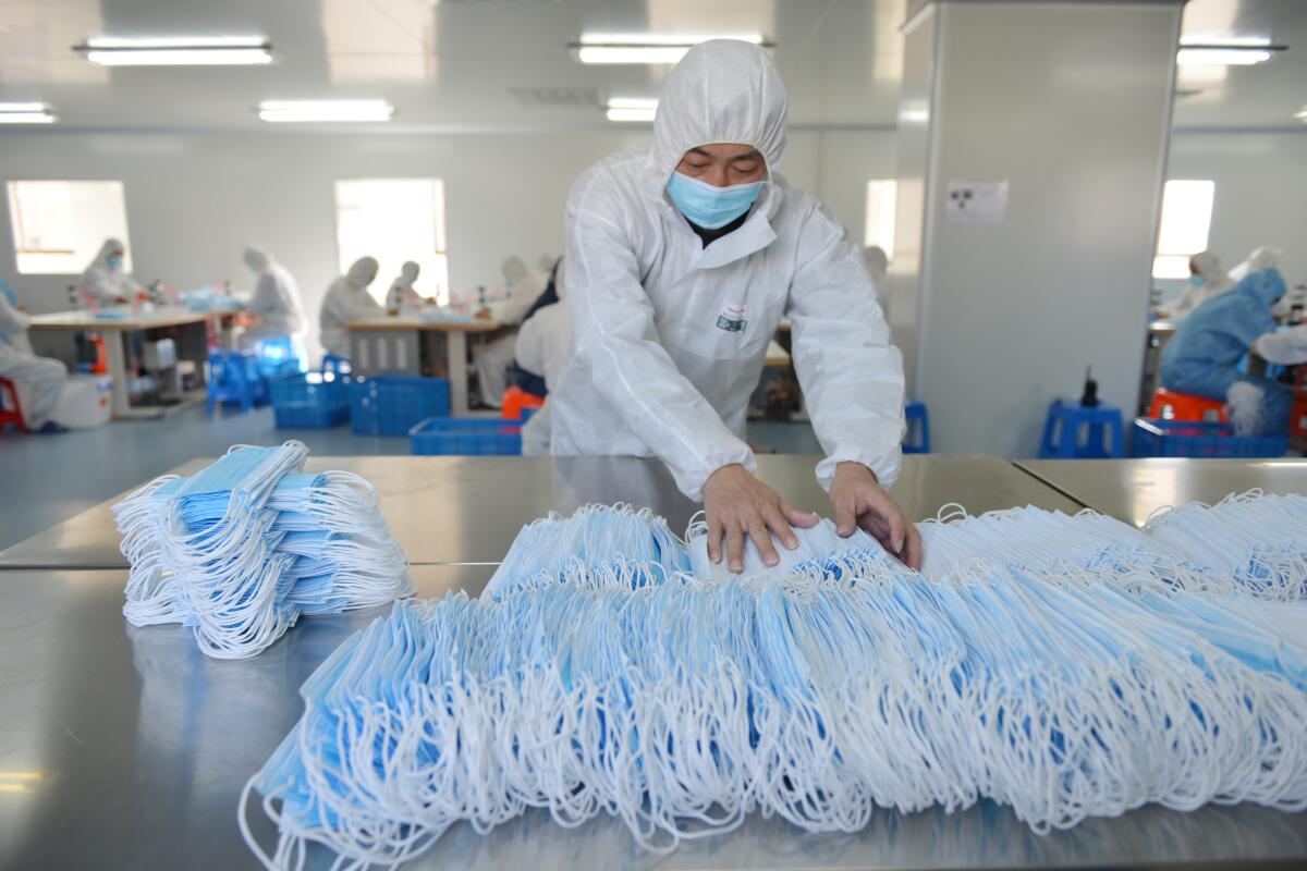A worker makes masks on a production line in Nanjing, China, in February.