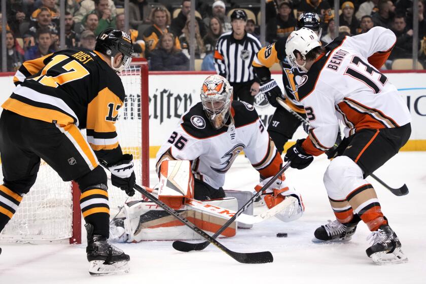 Anaheim Ducks goaltender John Gibson (36) blocks a shot by Pittsburgh Penguins' Bryan Rust.