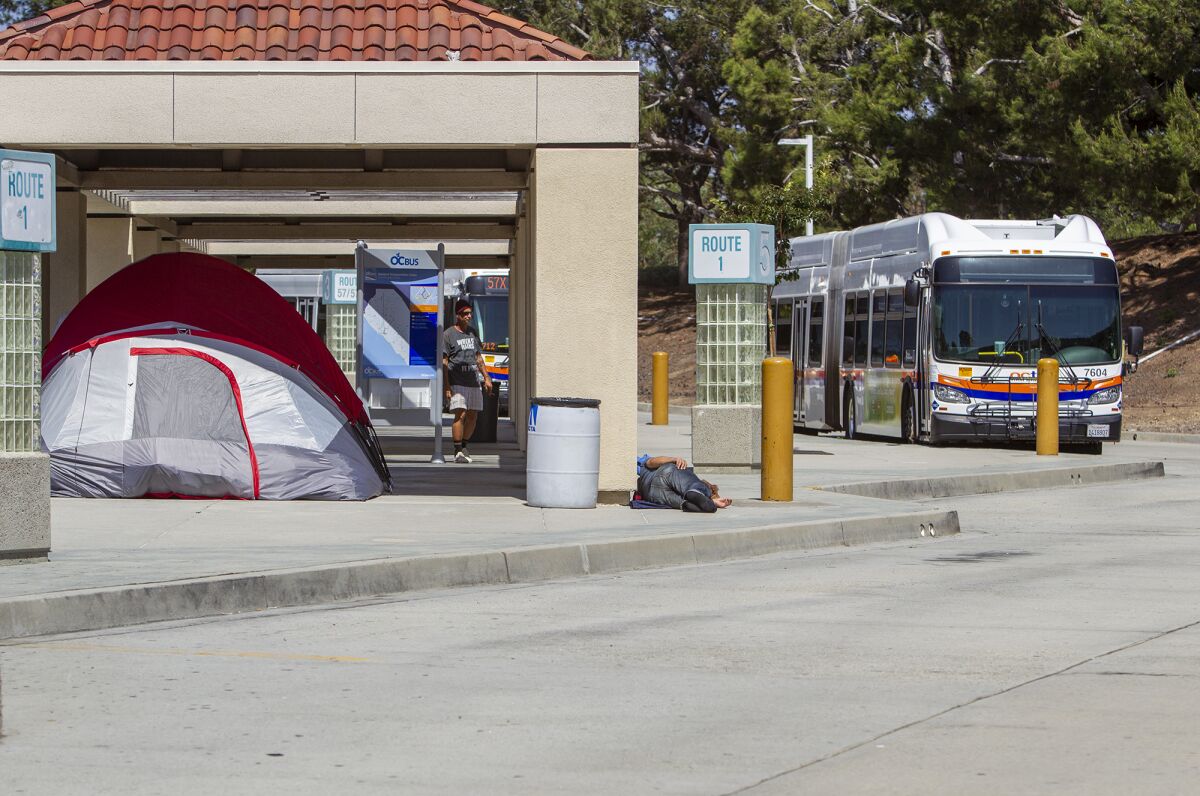 Tents housing homeless people lined the sidewalks and dirt slope in and around the Newport Beach Transportation Center earlier this month before the city began enforcing trespassing regulations on request from the Orange County Transportation Authority.
